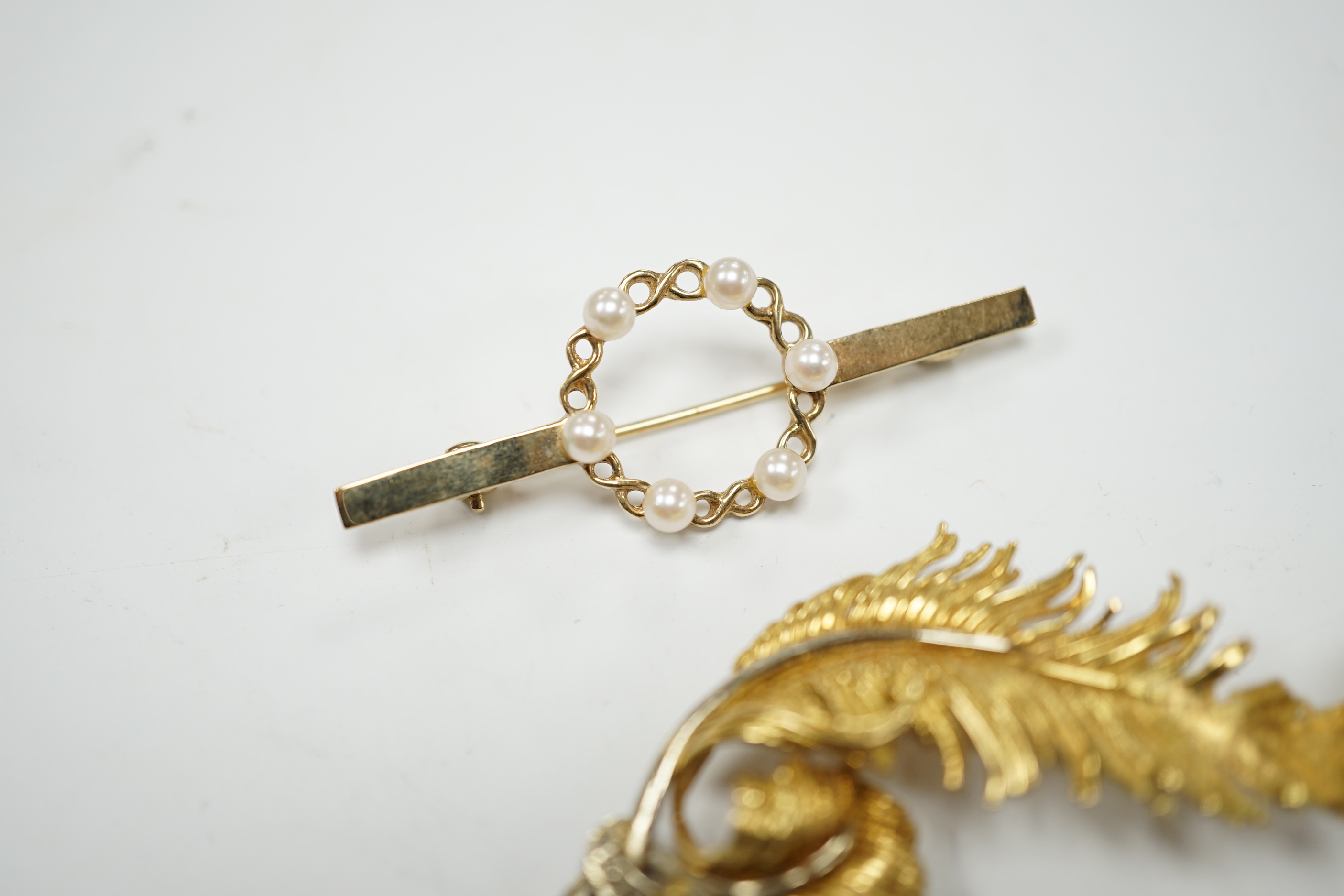 A 1960's 18ct gold and diamond chip set scrolling fern brooch by Cropp & Farr, 52mm, an 18ct heart and crescent brooch, gross weight 11.9 grams and a 9ct and seed pearl bar brooch, gross weight 2.8 grams.